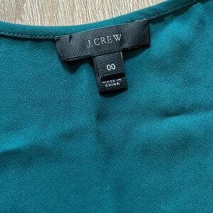 Sleeveless green JCrew silk shirt.